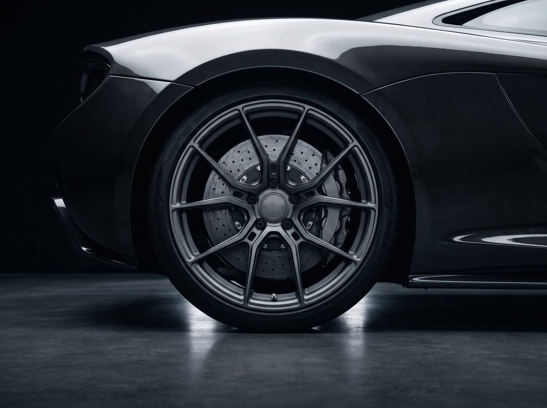 A forged multi-spoke wheel on a supercar, the carbon-ceramic disc and caliper visible behind the spokes